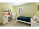 Cozy bedroom featuring a white bed, study desk, and ample natural light from the shuttered window at 1892 W Kettle Ave, Littleton, CO 80120