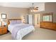 Comfortable bedroom features neutral tones, plush carpet, ceiling fan, and plenty of natural light at 1892 W Kettle Ave, Littleton, CO 80120