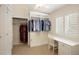 Spacious closet area has built-in storage solutions, carpet, and plenty of natural light at 1892 W Kettle Ave, Littleton, CO 80120