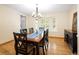 Bright dining room features hardwood floors, black dining set, and a window with natural light at 1892 W Kettle Ave, Littleton, CO 80120