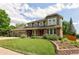 Attractive home showcasing mature trees, a brick facade and well maintained lawn at 1892 W Kettle Ave, Littleton, CO 80120
