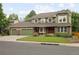 Inviting front of home featuring green trim, brick accents and a large front lawn at 1892 W Kettle Ave, Littleton, CO 80120