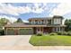 Charming two-story home with a three-car garage and well-manicured lawn at 1892 W Kettle Ave, Littleton, CO 80120
