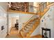 Bright foyer with wood flooring, staircase, decorative iron railings, and second story book shelves at 1892 W Kettle Ave, Littleton, CO 80120