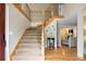 Open foyer with hardwood floors, staircase with decorative iron railings, and view of living area at 1892 W Kettle Ave, Littleton, CO 80120