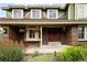 Close up of the front entrance with brickwork, hanging flower baskets and a red door at 1892 W Kettle Ave, Littleton, CO 80120