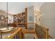 Hallway with a built-in bookcase and railing overlooking staircase at 1892 W Kettle Ave, Littleton, CO 80120