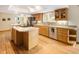 Bright kitchen featuring stainless steel appliances, wood cabinets, granite counters, and hardwood floors at 1892 W Kettle Ave, Littleton, CO 80120