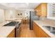 Stylish kitchen featuring a gas stove, wood cabinets, and stainless steel refrigerator at 1892 W Kettle Ave, Littleton, CO 80120
