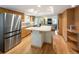 Modern kitchen with stainless steel appliances and granite countertops that connect to the living room at 1892 W Kettle Ave, Littleton, CO 80120