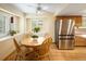Eat-in kitchen boasts stainless steel appliances, lots of sunlight, hardwood floors, and a ceiling fan at 1892 W Kettle Ave, Littleton, CO 80120