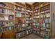 Home library features custom wood built-ins, plush chair, and window with natural light at 1892 W Kettle Ave, Littleton, CO 80120