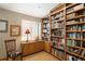 Cozy office with custom wood built-ins, plush chair, and window with lots of natural light at 1892 W Kettle Ave, Littleton, CO 80120