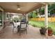 Covered patio with a dining table, grill, and beautiful landscaping, perfect for outdoor entertaining and relaxation at 1892 W Kettle Ave, Littleton, CO 80120