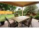 Inviting patio area with dining set, a covered pergola, and views of the manicured lawn, ideal for outdoor dining at 1892 W Kettle Ave, Littleton, CO 80120