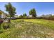 View of backyard featuring a deck, healthy lawn, and a wooden fence at 10895 Fairfax Way, Thornton, CO 80233