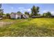 Wide shot of the backyard featuring a deck, healthy lawn, and a wooden fence at 10895 Fairfax Way, Thornton, CO 80233