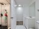 Bathroom featuring a sink vanity with a mirror and a shower with white tiling and a rainfall shower head at 10895 Fairfax Way, Thornton, CO 80233