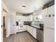 Clean kitchen with white cabinetry, stainless steel dishwasher, and ample counter space at 10895 Fairfax Way, Thornton, CO 80233