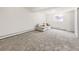 Spacious room featuring neutral paint, carpet, and furniture providing a clean and inviting space at 10895 Fairfax Way, Thornton, CO 80233