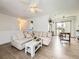 Spacious living room boasts modern lighting, stylish seating, and access to the dining area at 10895 Fairfax Way, Thornton, CO 80233