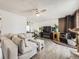 Bright living room featuring a cozy fireplace, modern ceiling fan, and comfortable seating area at 10895 Fairfax Way, Thornton, CO 80233