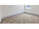 A simple room featuring neutral paint and carpet providing a clean and versatile space at 10895 Fairfax Way, Thornton, CO 80233