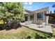 Spacious patio with a dining area and lounge chair overlooking a lush green lawn at 744 Kryptonite Dr, Castle Rock, CO 80108