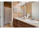 Well-lit bathroom with a double sink vanity, neutral paint, and shower with curtain at 744 Kryptonite Dr, Castle Rock, CO 80108