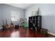 Bedroom featuring hardwood floors, a keyboard, guitars and a storage shelf at 744 Kryptonite Dr, Castle Rock, CO 80108