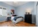Cozy bedroom with hardwood floors, a ceiling fan, and light blue walls at 744 Kryptonite Dr, Castle Rock, CO 80108