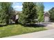 Well-maintained home with lush green lawn and mature trees at 744 Kryptonite Dr, Castle Rock, CO 80108