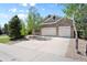 Charming brick home featuring a two-car garage and landscaped front yard at 744 Kryptonite Dr, Castle Rock, CO 80108