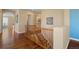 Upstairs hallway with hardwood floors and wood railing to the lower level at 744 Kryptonite Dr, Castle Rock, CO 80108