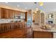 Gourmet kitchen featuring granite counters, stainless appliances, and custom wood cabinets at 744 Kryptonite Dr, Castle Rock, CO 80108