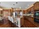 Well-lit kitchen boasts a large island, stainless steel appliances, and ample wood cabinetry at 744 Kryptonite Dr, Castle Rock, CO 80108