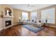 Comfortable living room with fireplace, large sectional couch and blue accent rug at 744 Kryptonite Dr, Castle Rock, CO 80108