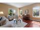 Bright living room with hardwood floors, large windows, and stylish furniture at 744 Kryptonite Dr, Castle Rock, CO 80108
