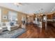 Bright open-concept living area flows seamlessly into the kitchen and dining space with hardwood floors at 744 Kryptonite Dr, Castle Rock, CO 80108