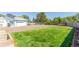 View of a large grassy backyard leading to a detached garage at 833 Applewood Dr, Lafayette, CO 80026