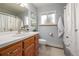 Bathroom featuring a wood vanity, sink, toilet, and shower with curtain at 833 Applewood Dr, Lafayette, CO 80026