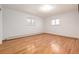 A bright, empty bedroom featuring wood floors and natural light from two windows at 833 Applewood Dr, Lafayette, CO 80026