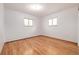 Sunny bedroom with hardwood floors, radiator, and windows at 833 Applewood Dr, Lafayette, CO 80026