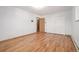 Bright bedroom with gleaming hardwood floors, closet, and neutral paint at 833 Applewood Dr, Lafayette, CO 80026