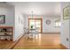 Bright dining room featuring hardwood floors, table, chairs, and slider to patio at 833 Applewood Dr, Lafayette, CO 80026