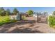 Gated gravel driveway and partial view of a brick house at 833 Applewood Dr, Lafayette, CO 80026