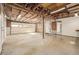 Spacious garage with exposed ceiling beams and ample room for parking and storage at 833 Applewood Dr, Lafayette, CO 80026