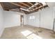 Spacious garage with unfinished walls, concrete flooring, and exposed ceiling beams at 833 Applewood Dr, Lafayette, CO 80026