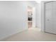 Bright hallway leading to a bedroom and featuring tile floors at 833 Applewood Dr, Lafayette, CO 80026