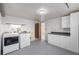 Laundry room with appliances, cabinetry, and bright lighting for convenient chores at 833 Applewood Dr, Lafayette, CO 80026